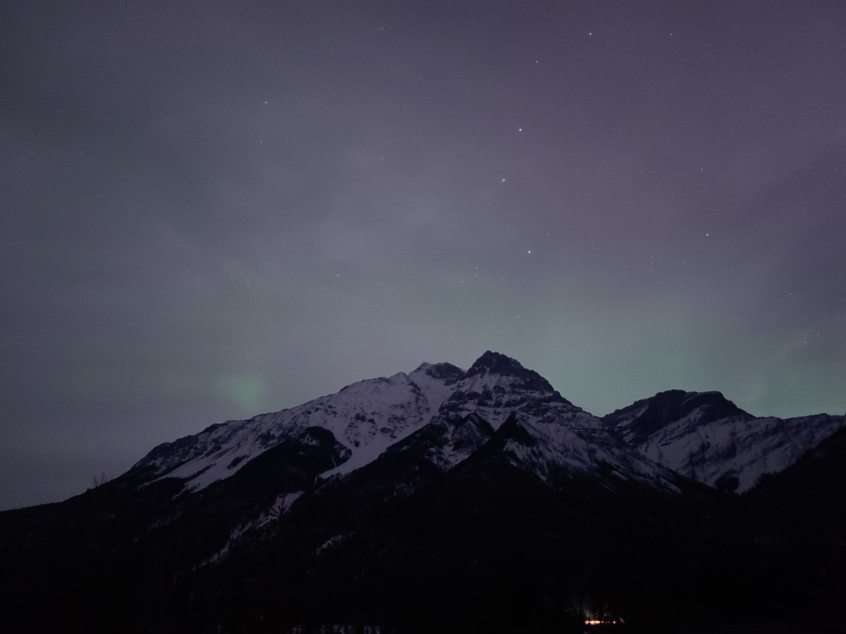 Mountain silhouettes under a dark starry sky near Golden, British Columbia