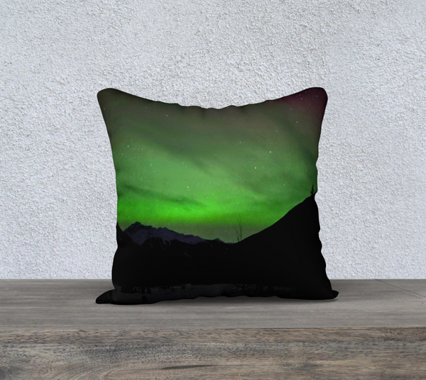Green Aurora Mountain Throw Pillow | Northern Lights Cushion — aurora borealis over dark mountain silhouettes