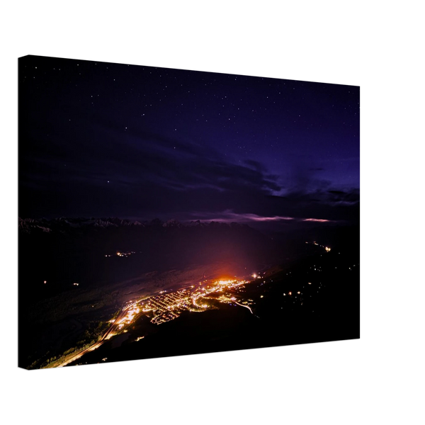 Mountain Town Lights Canvas Print – Canadian Rockies Northern Lights Wall Art — aurora borealis over a mountain town's glowing lights